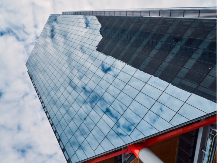 Clouds reflected in the glass facade of a building