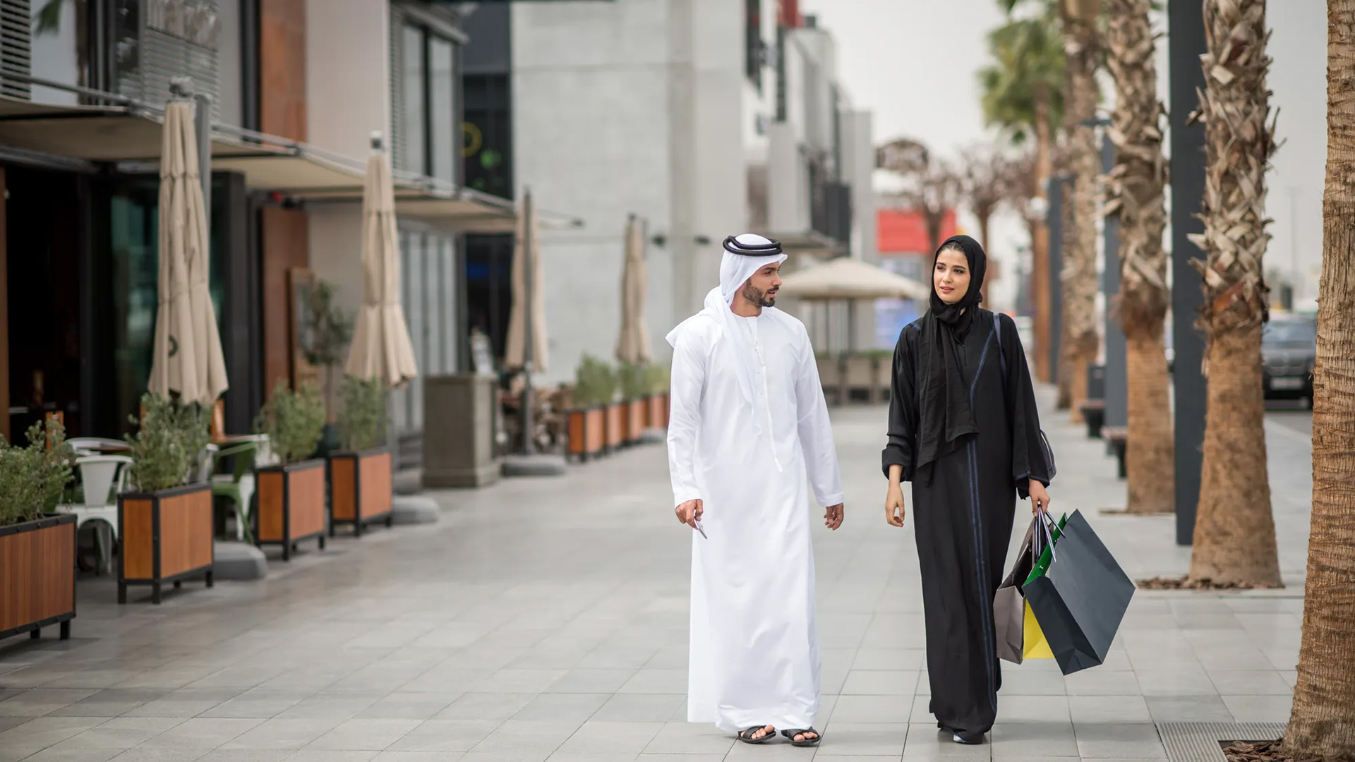 Man and woman walking through a city