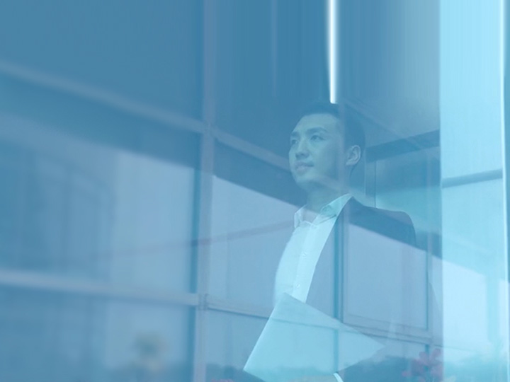 Man looking out window