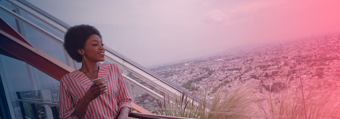 Woman at a balcony overlooking a city