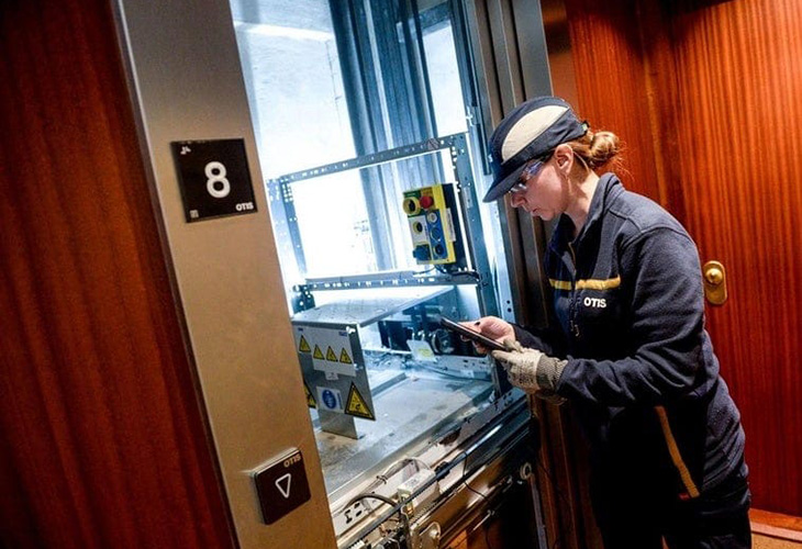 female technician working on an elevator 