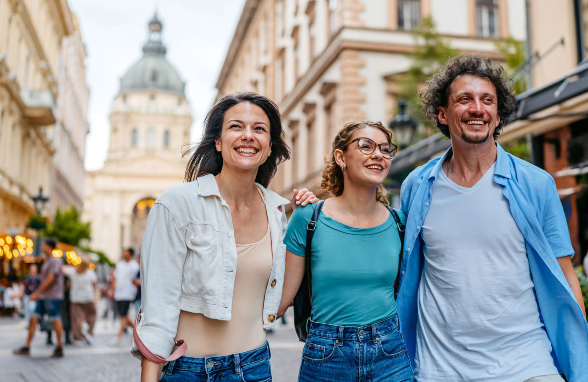 3 people smiling in the street