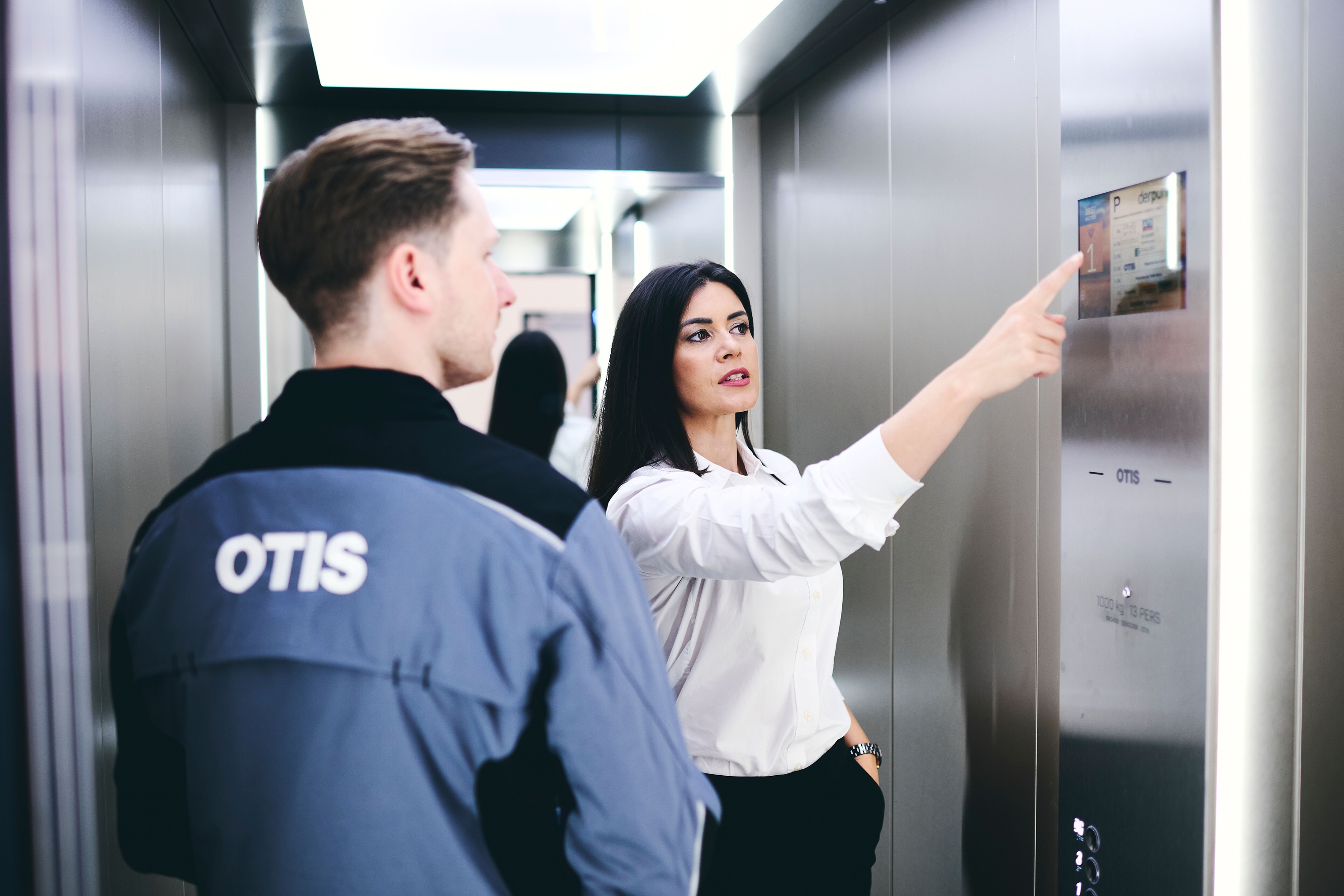 Otis engineers observing elevator