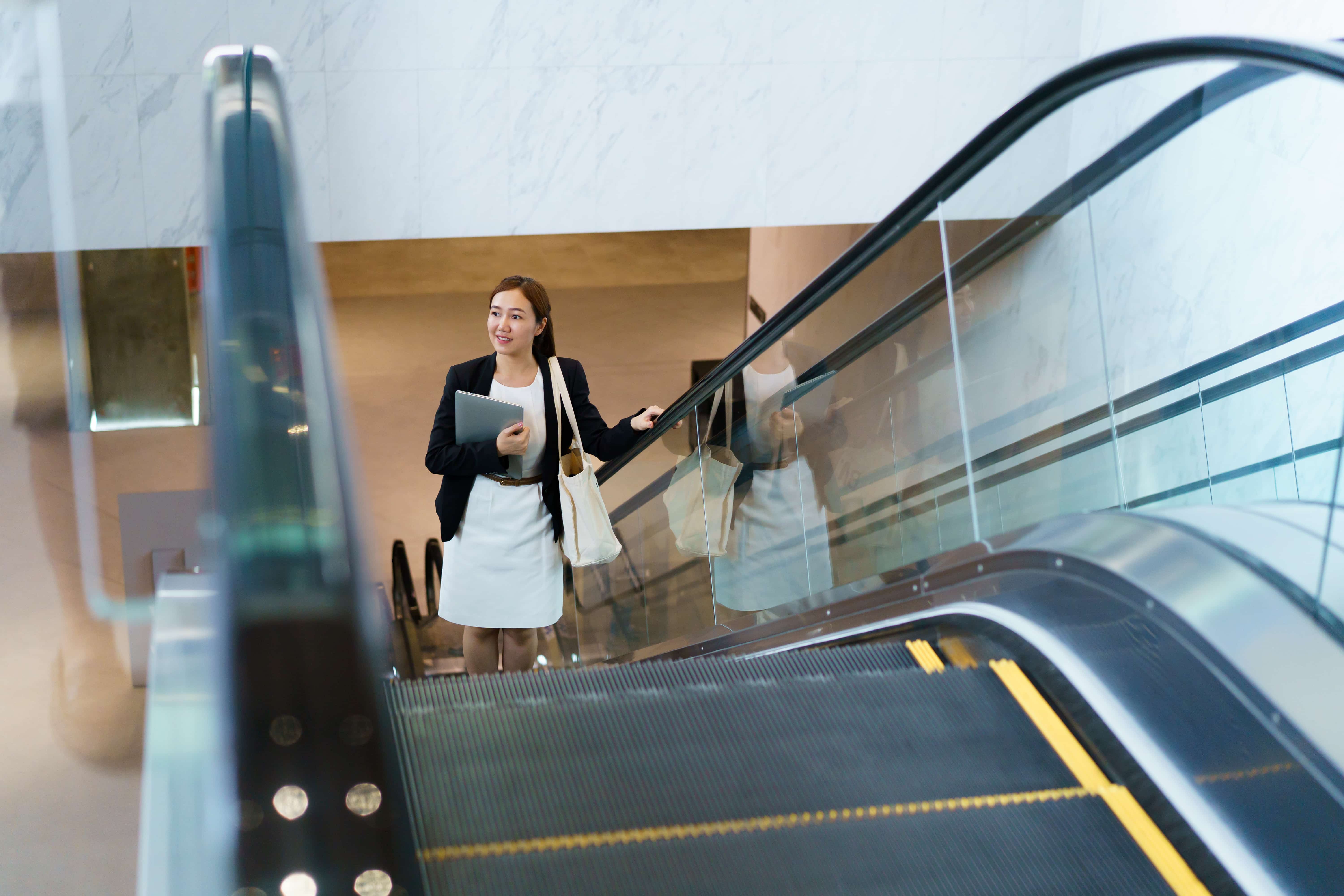 Women riding up an escalator