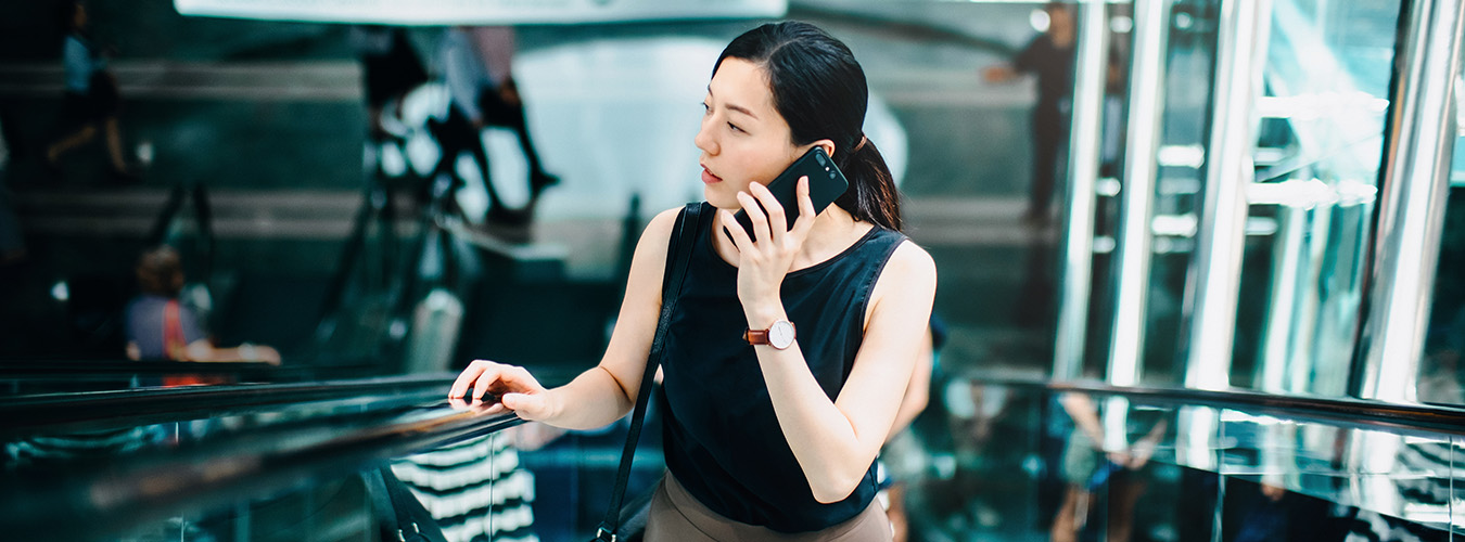 Woman riding an escalator