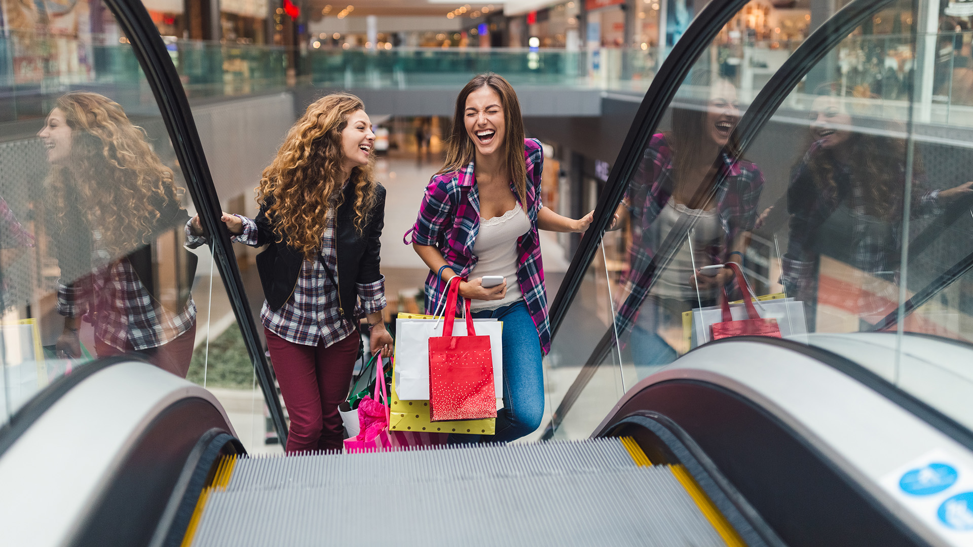 Women riding up an escalator