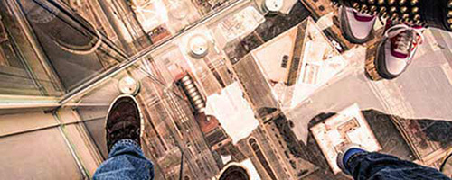 Looking down through glass elevator