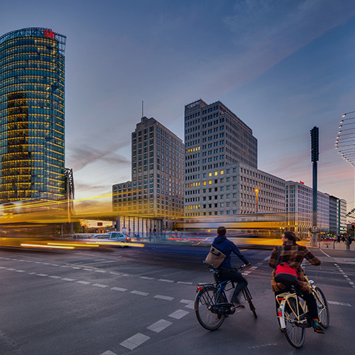 Two people riding bikes in the city